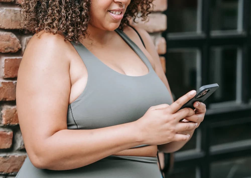 A woman comfortably reviewing her health assessment on her phone at home